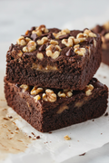Southern Gossip Turtle Brownie - stacked brownies with chopped walnuts